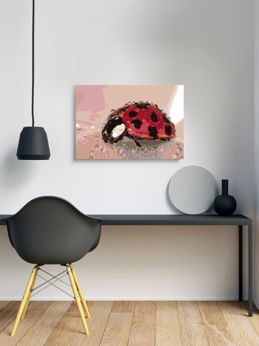 a painting of a ladybug on a wall above a desk