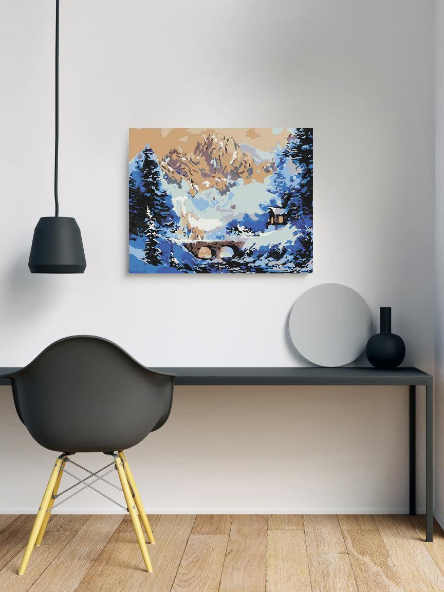 a painting on a wall above a desk