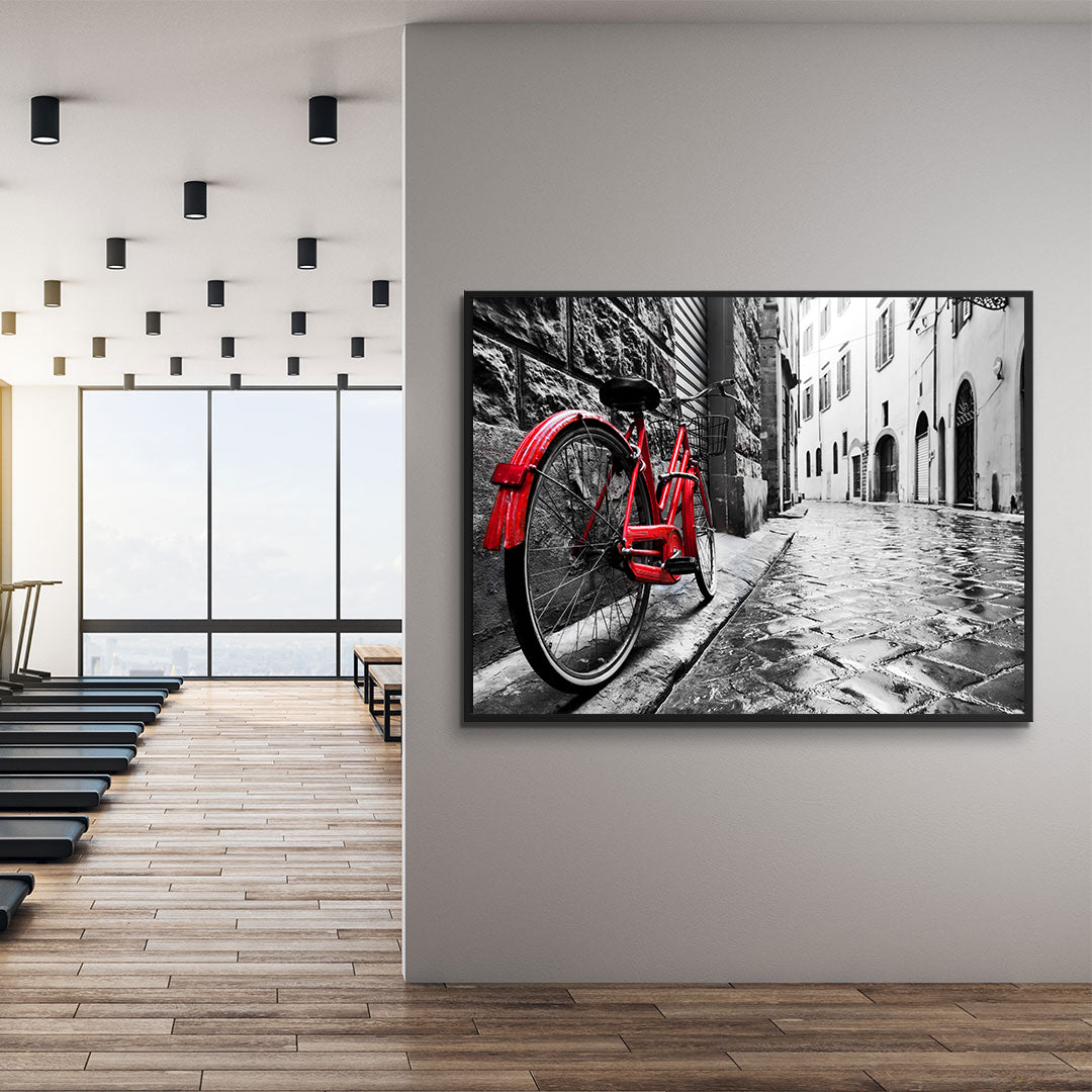 Leinwandbild - Rotes Fahrrad in der Stadt